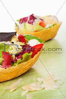 Taco shell filled with salad.