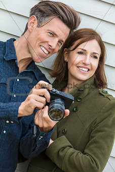 Happy Middle Aged Man and Woman Couple Using Camera