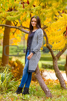 portrait of pretty teen girl in autumn park