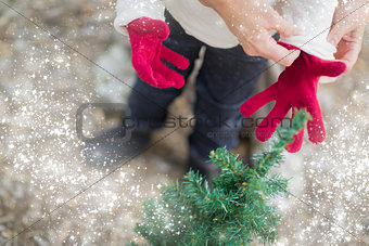 Mother Putting Red Mittens On Child with Snow Effect