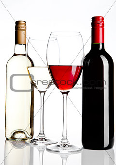Bottles and glass of red and white wine reflection