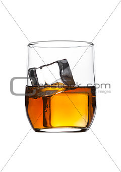 Glass of whiskey with ice cubes isolated on white