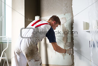 Plasterer renovating indoor walls and ceilings.
