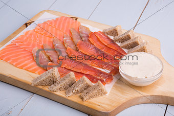 Sliced fish meat on wooden board
