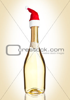 Bottle of yellow champagne with santa hat 