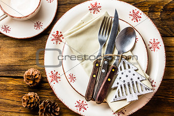 Christmas table setting on wooden background. Top view