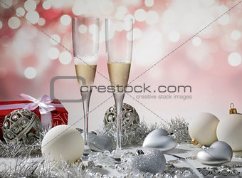 two glasses of champagne for christmas celebration with red deco