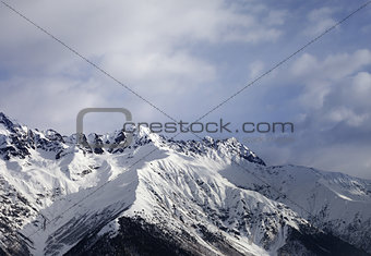 Snow mountain and gray sky at winter evening