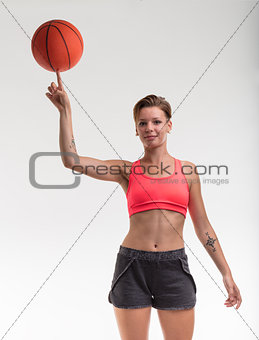 woman balancing a basketball on her finger