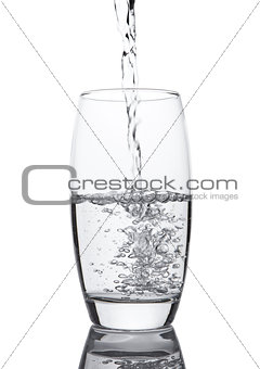 Pouring cold fresh healthy still water to glass