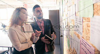 Businessman and businesswoman communicating in office