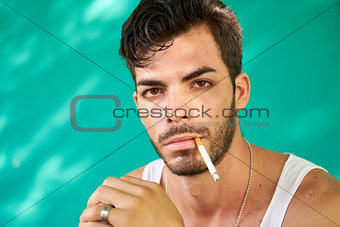 Portrait Of Young Hispanic Man Smoking Cigarette