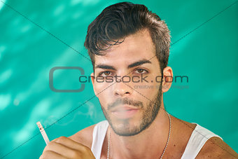 Young Hispanic Man Smoking Cigarette And Blowing Smoke