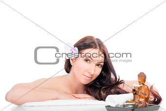 Portrait of a brunette with a flower in her hair on a spa proced
