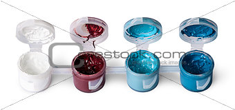 Few colored acrylic paints in open jars