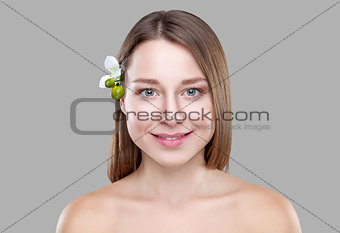 Beautiful brunette woman with a white flower 