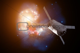 Cargo spacecraft - The Automated Transfer Vehicle over spiral galaxy.