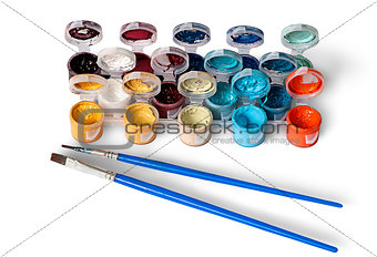 Set of colorful acrylic paints in jars and two brushes