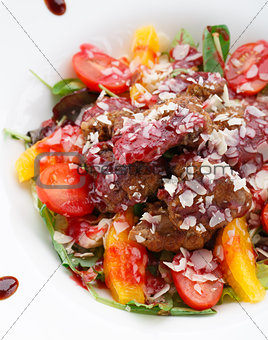 Warm salad with chicken liver in raspberry sauce