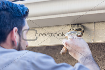 Professional Painter Using Brush to Paint House Fascia 