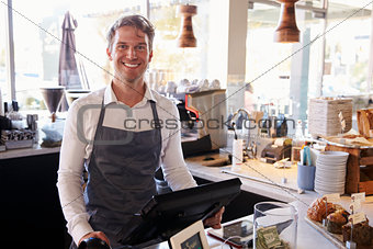 Portrait Of Male Employee Working At Delicatessen Checkout