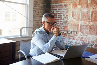 Thoughtful Mature Businessman In Boardroom