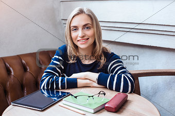 Woman smiling portrait of happy lovely and beautiful woman in casual clothes indoor sitting in cafe