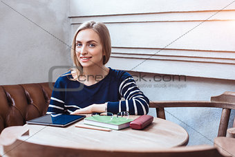 Woman smiling - portrait of happy lovely and beautiful woman in casual clothes indoor sitting in cafe