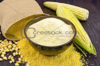 Flour corn in bowl with bag on board