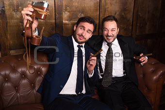 Rich businessmen with cigars