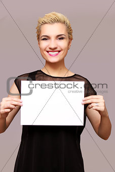 beautiful woman smiling, holding a place for an inscription