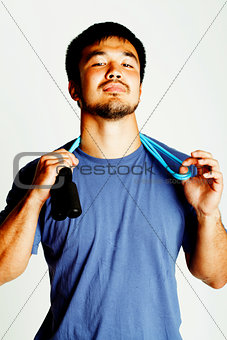 young asian guy with skipping rope on white background ready to