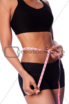 Healthy fit woman measuring waste