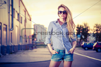 Trendy Hipster Girl at Sunset in the City