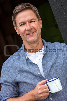 Happy Middle Aged Man Drinkng Tea or Coffee Outside