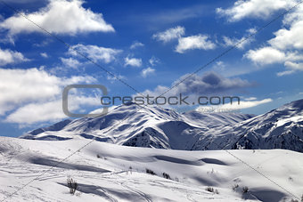 Ski slope and beautiful sky with clouds in sunny evening