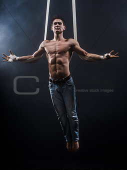 circus artist on the aerial straps man