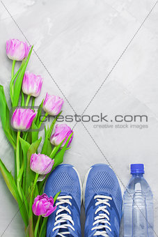 Spring flatlay sports composition with blue sneakers and purple 