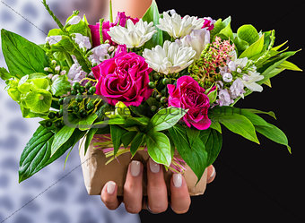 female hands holding gift and vintage wedding bouquet of rose