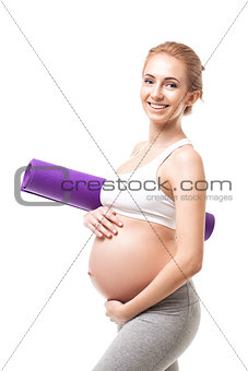 Pregnant Woman Holding A Purple Exercise Mat