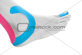 Therapeutic tape on female ankle.