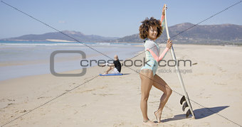 Female posing with surfboard on beach