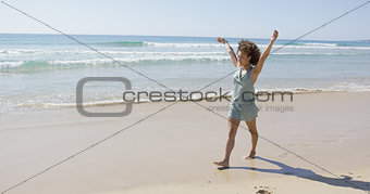 Female walking along the shore of beach