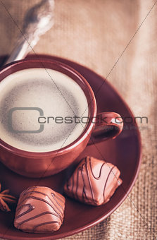Cup fragrant hot coffee with bean chocolate