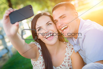 Happy Mixed Race Couple Taking Self Portrait with A Smart Phone 