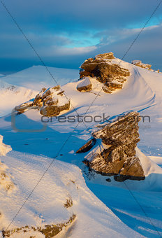 rock covered with snow and fog