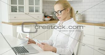 Successful young woman using devices