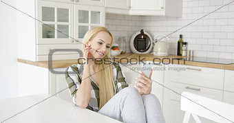 Charming female taking selfie in kitchen