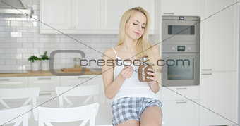 Fit lovely girl eating chocolate spread
