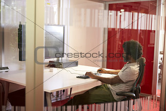 Male Student Working In Classroom With Large Screen